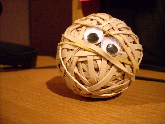 a rubber band ball with googly eyes on it