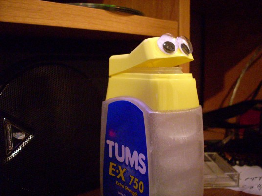 a container of tums with googly eyes on it